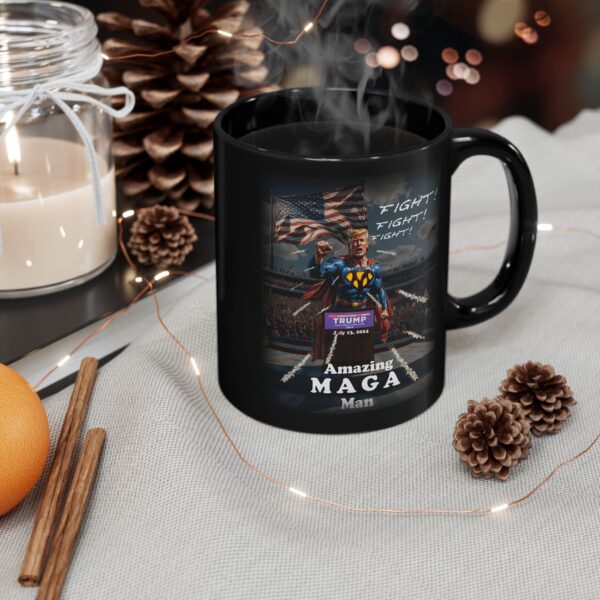 Amazing MAGA Man Mug Black Ceramic next to a scented candle