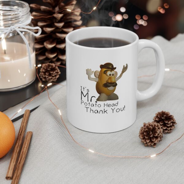 mr. potato head mug beside a scented holiday candle