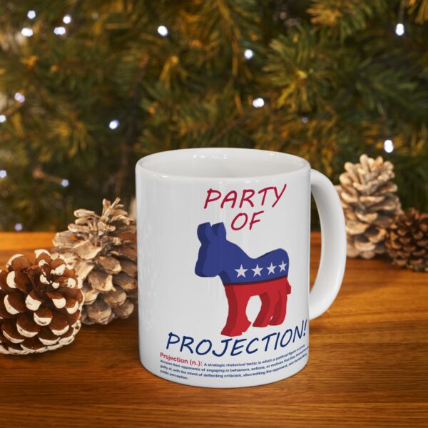 Party Of Projection white ceramic mug on table next to Christmas tree