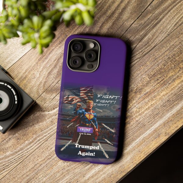 Purple Custom Trumped Again Tough Phone Cases for iPhone 15 Pro Max on a table