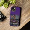 Purple Custom Trumped Again Tough Phone Cases for iPhone 15 on a table