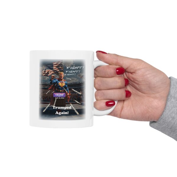 Woman holding a Trumped Again! White ceramic mug with one hand