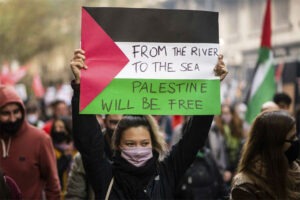 young idiot holding pro-hamas sign